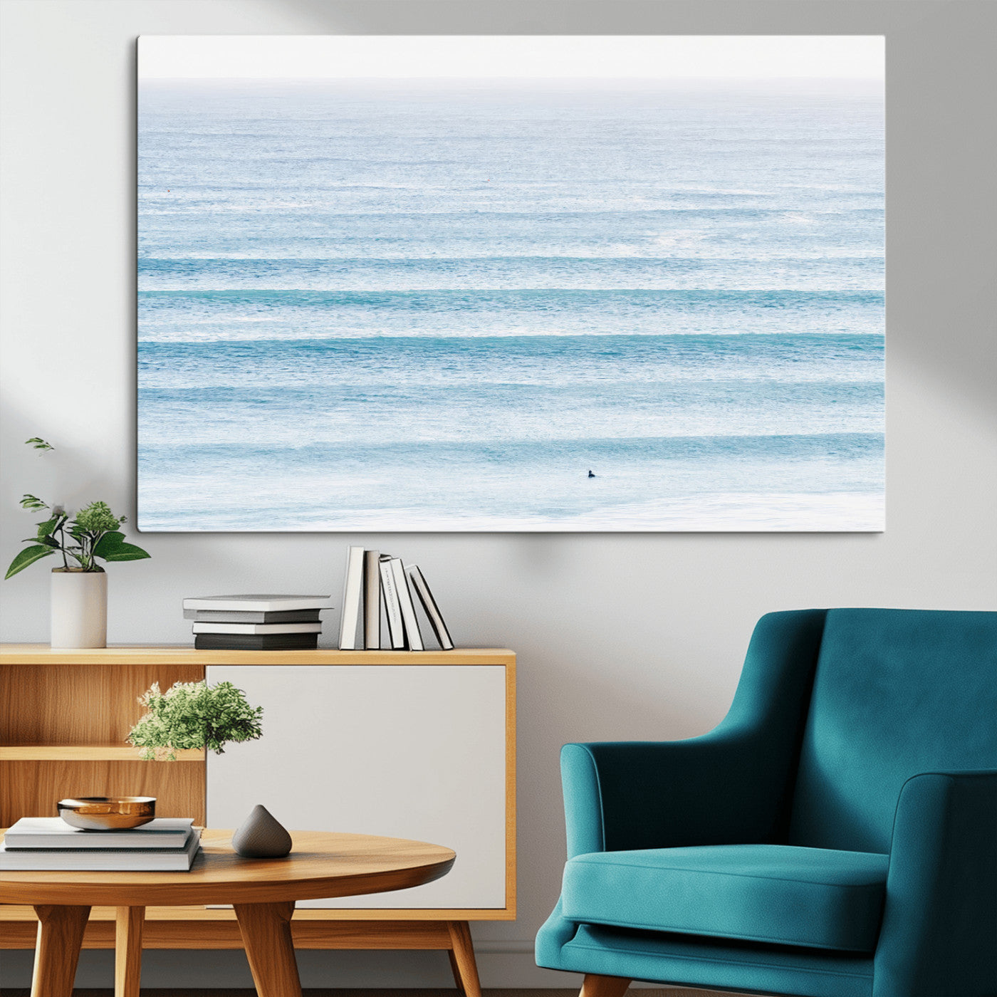 Minimalist ocean view with soft blue waves and a lone surfer, creating a serene and airy coastal aesthetic, perfect for tranquil home decor.