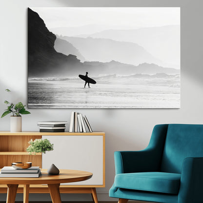 A lone surfer walking along a misty beach with cliffs in the background, carrying their board, capturing a serene and minimal ocean moment.
