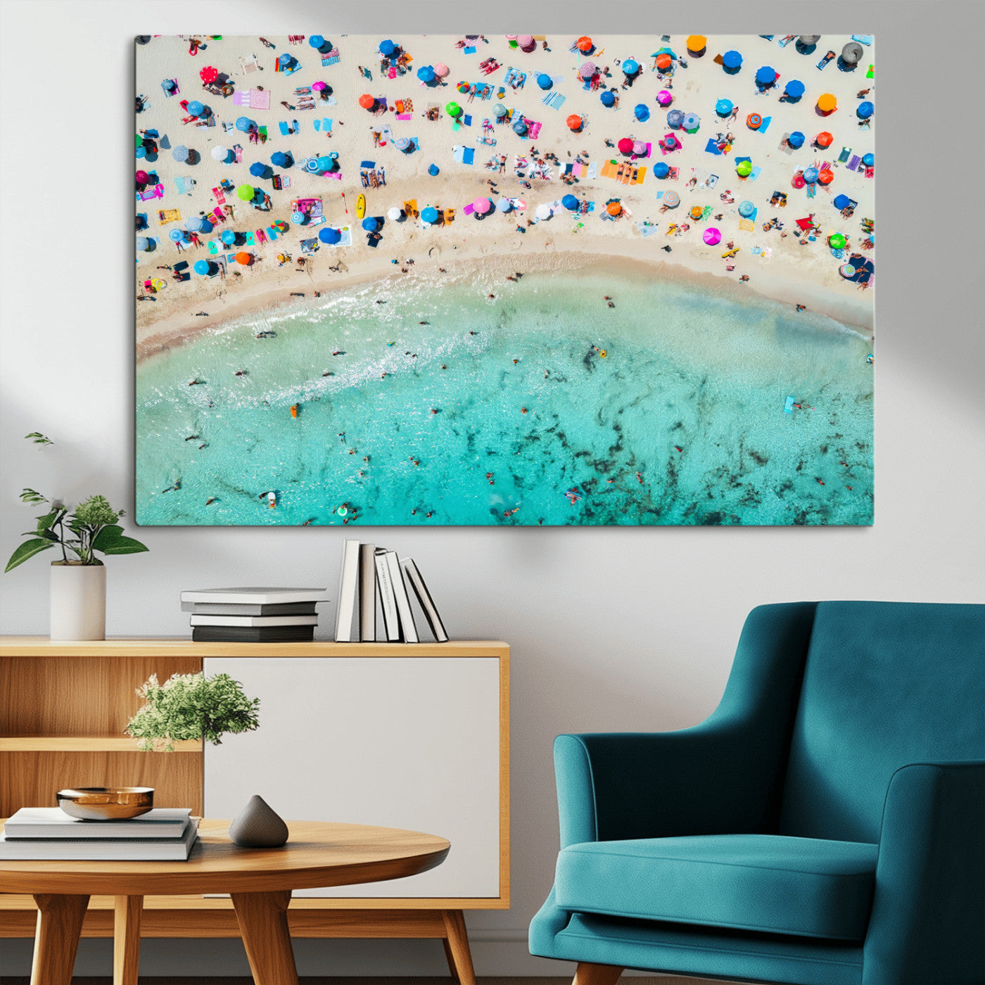 Aerial view of a vibrant beach filled with colorful umbrellas and people enjoying the turquoise ocean, capturing a lively summer vacation scene.