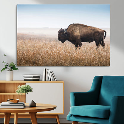 A majestic bison standing in an open prairie field, its strong form blending into the golden grass under a vast blue sky, evoking the wild spirit of the American plains.