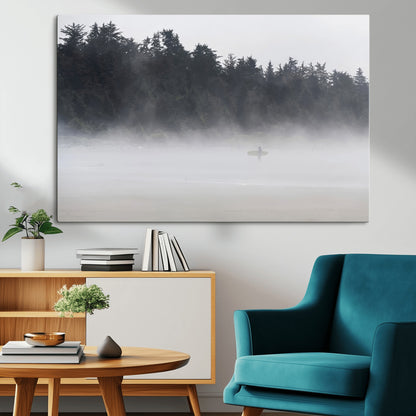 A lone surfer carrying a board through a misty shoreline, surrounded by dense trees and fog, creating a peaceful and mysterious coastal scene.