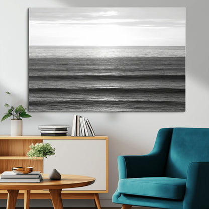 Minimalist black and white ocean view with layered waves reflecting sunlight, evoking a sense of calm and coastal serenity.