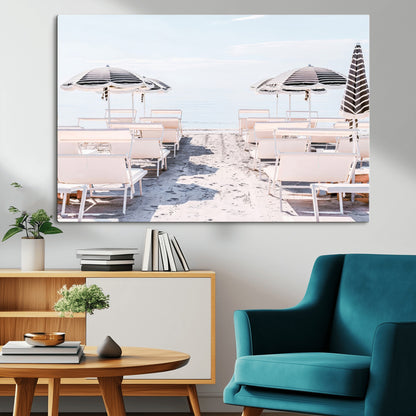 A serene minimalist beach scene featuring striped umbrellas, soft pastel sand, and an elegant lounge setup, creating a tranquil and stylish coastal retreat.
