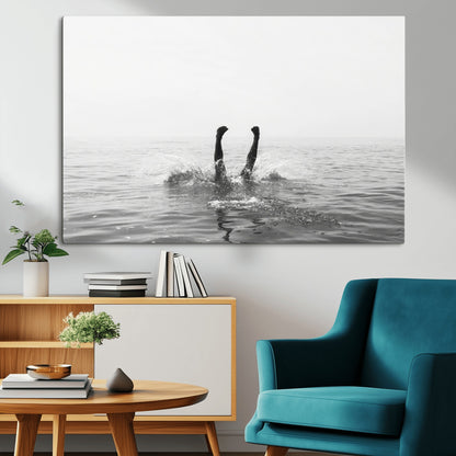A black and white minimalist water scene capturing a playful splash as a swimmer dives upside down, creating a carefree and artistic aquatic aesthetic.