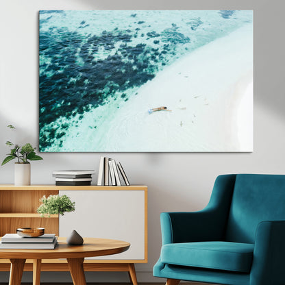 Canvas featuring an aerial view of a swimmer in shallow turquoise waters with coral patterns, ideal for tropical coastal home decor.