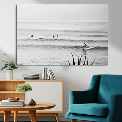 Monochrome canvas of surfers on calm ocean waves, ideal for minimalist coastal or beach-inspired interior decor.