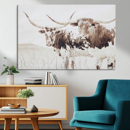 Two longhorn cows standing in a sepia-toned pasture with soft light, ideal for rustic or farmhouse-themed neutral wall decor.