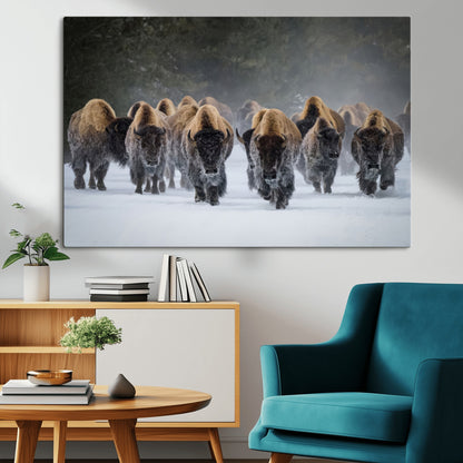 A herd of American bisons walking through deep snow in a forest, evoking a powerful rustic wilderness mood for western-style interiors.