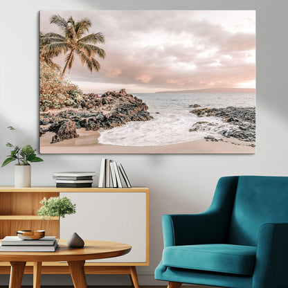 A peaceful beach scene with a palm tree and rocks, soft waves washing onto the shore under a soft pastel sky at sunset.