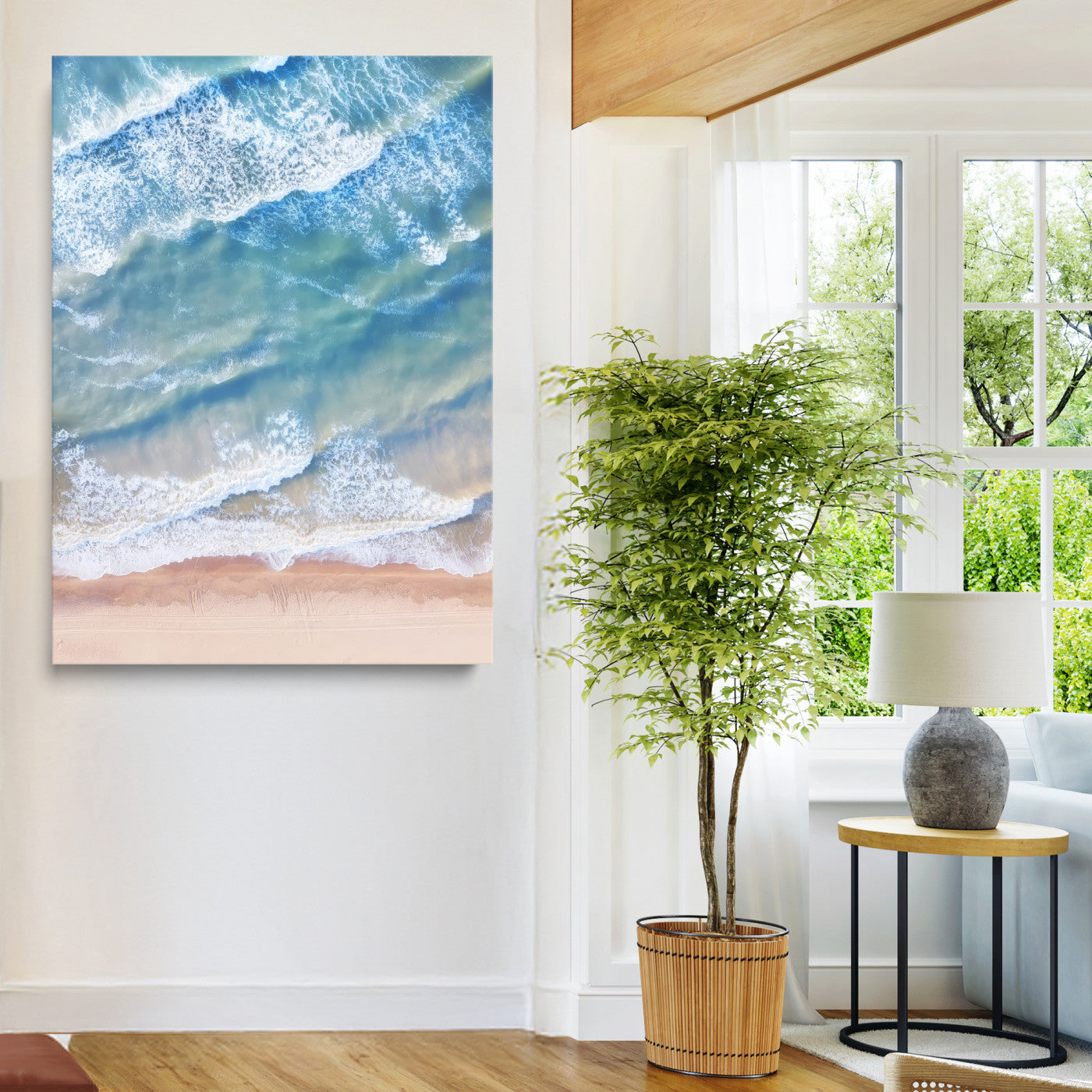 Aerial photo of soft blue waves meeting sandy shore, perfect for modern coastal or beach-themed decor with a light and tranquil aesthetic.