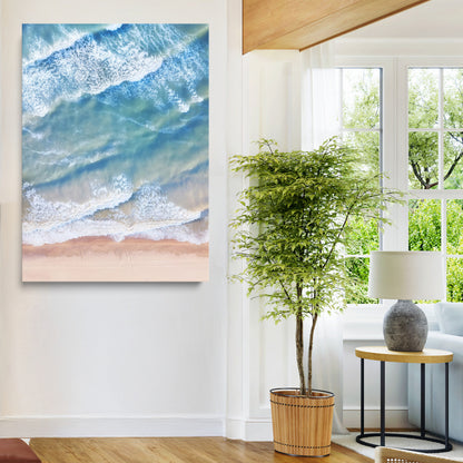 Aerial photo of soft blue waves meeting sandy shore, perfect for modern coastal or beach-themed decor with a light and tranquil aesthetic.