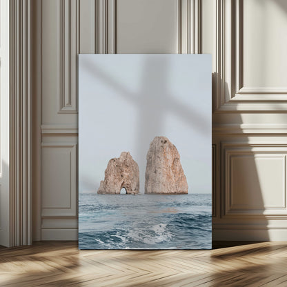 Serene photograph of the Faraglioni rocks in Capri with calm blue waters, perfect for Mediterranean coastal or minimalist travel-themed decor.