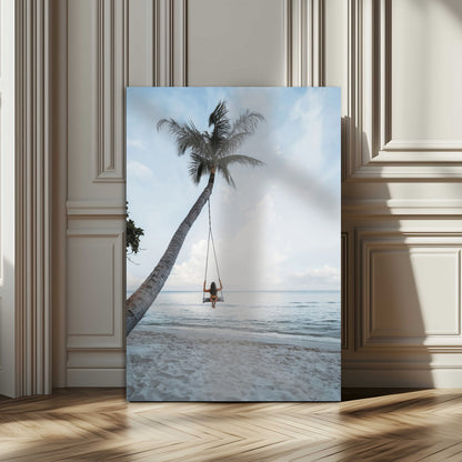 Wall art of a girl on a swing hanging from a palm tree over calm ocean waters, perfect for tropical or minimalist coastal decor.
