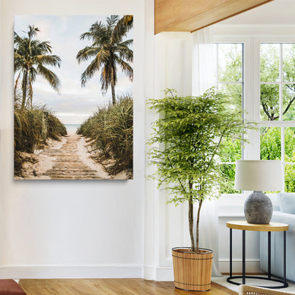 Canvas wall art of a tropical beach path with palm trees and dune grass, ideal for coastal entryways or tropical-inspired home decor.