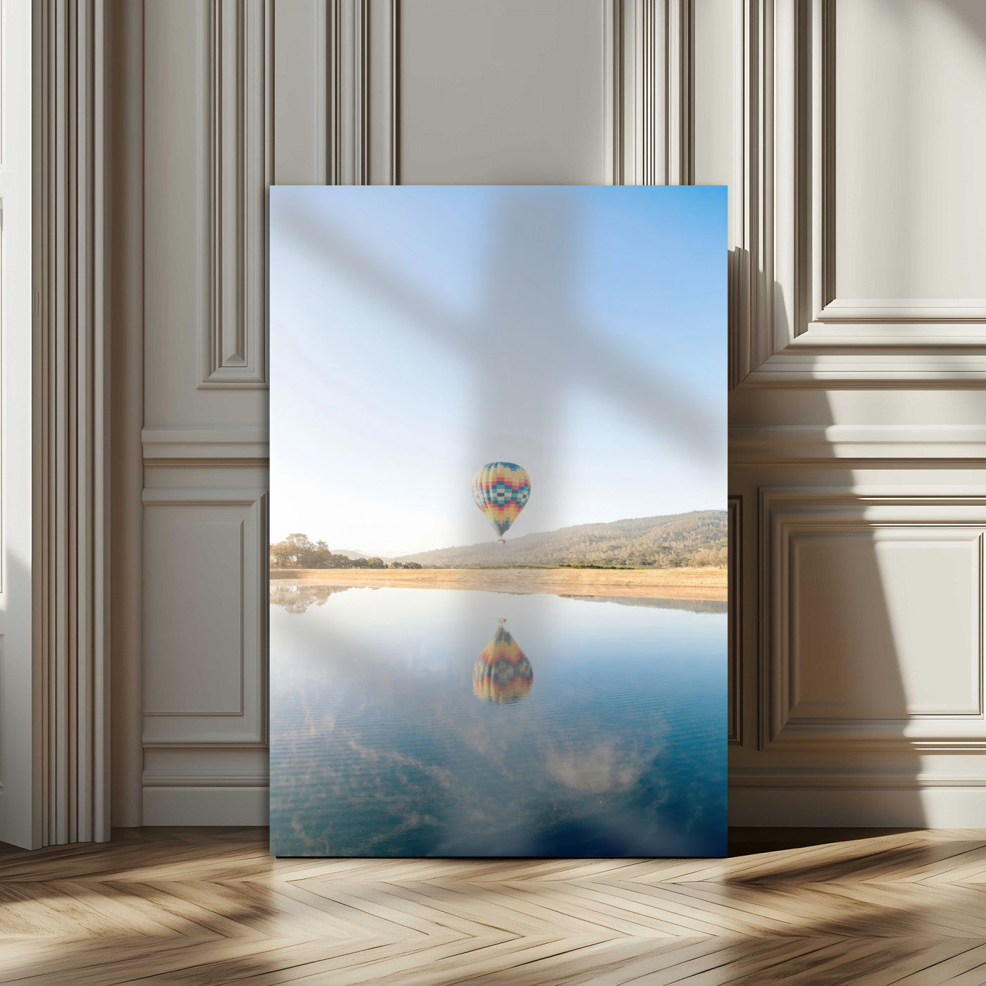 Canvas of a hot air balloon floating above a calm lake with soft reflections and vibrant sky, ideal for modern minimalist or adventure-themed home decor.