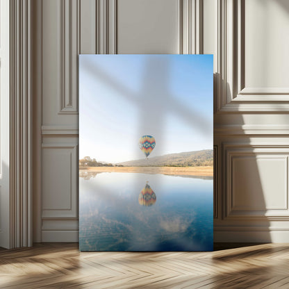 Canvas of a hot air balloon floating above a calm lake with soft reflections and vibrant sky, ideal for modern minimalist or adventure-themed home decor.