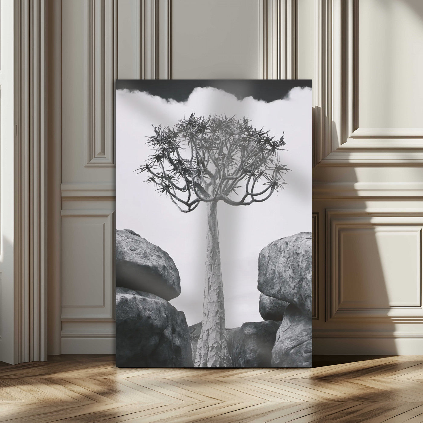 Tall desert tree in black and white, standing between large rocks, perfect for bold and minimalist nature-themed interior spaces.