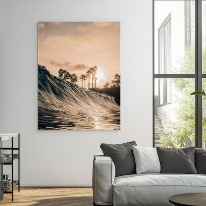 Golden sunset view of an ocean wave curling near palm trees, radiating warm tones perfect for coastal or tropical-themed decor.