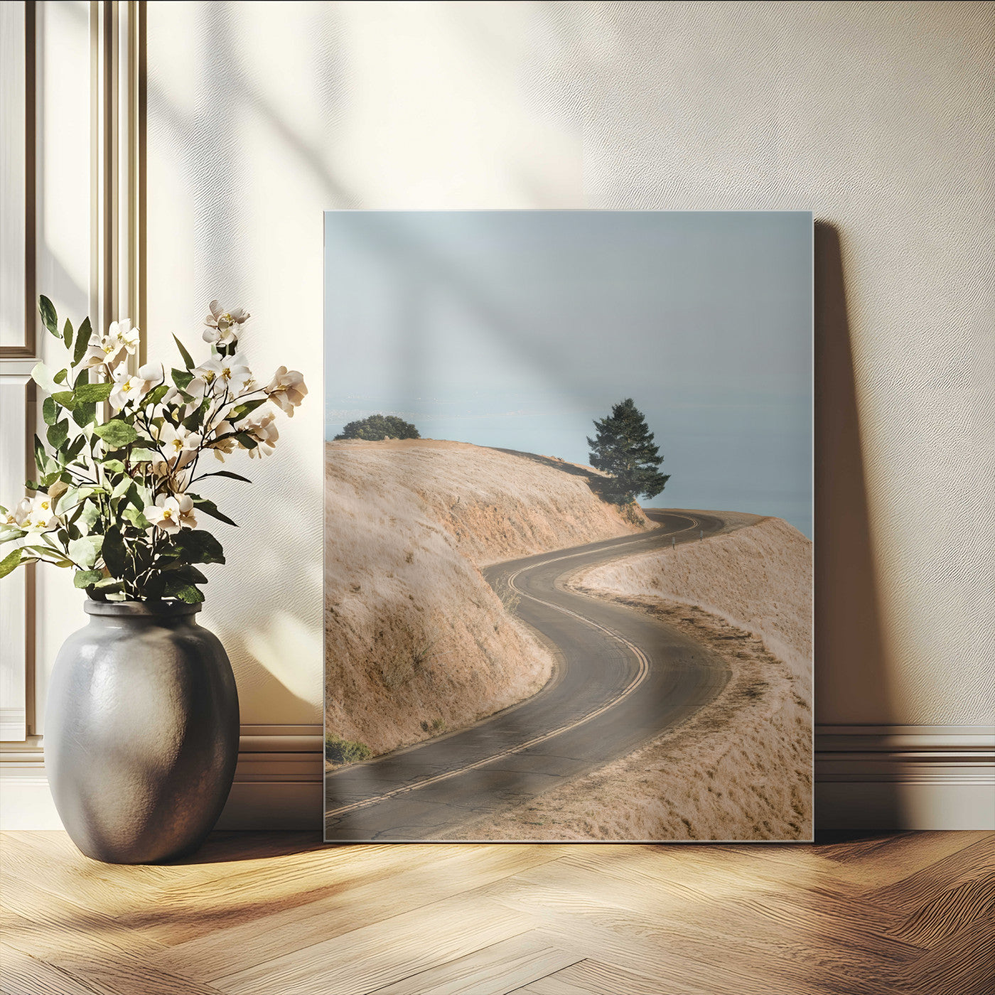 Earth-toned photograph of a winding road through golden hills, ideal for neutral or rustic-themed decor with a calming travel vibe.