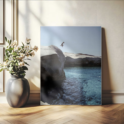 Canvas of a cliff diver above turquoise waters and rocky coastline under clear sky, ideal for adventurous minimalist or coastal home decor.