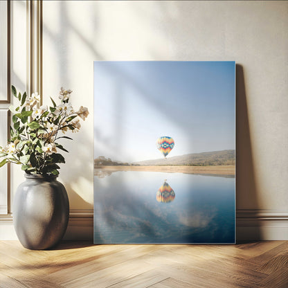 Canvas of a hot air balloon floating above a calm lake with soft reflections and vibrant sky, ideal for modern minimalist or adventure-themed home decor.