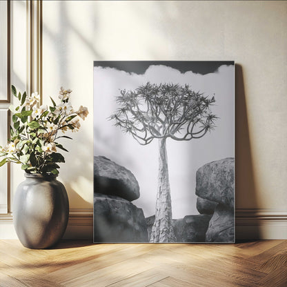 Tall desert tree in black and white, standing between large rocks, perfect for bold and minimalist nature-themed interior spaces.