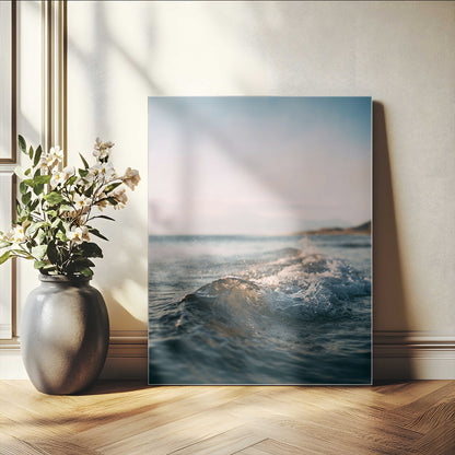 Close-up of ocean waves rolling gently toward the shore at sunset, creating a peaceful and minimalist coastal scene.