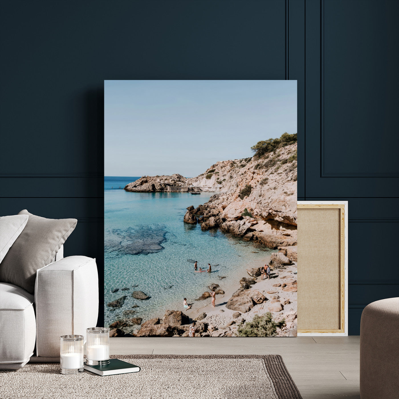 A vibrant coastal photo of a rocky Mediterranean cove with turquoise waters and beachgoers, ideal for boho coastal or summer-inspired interiors.