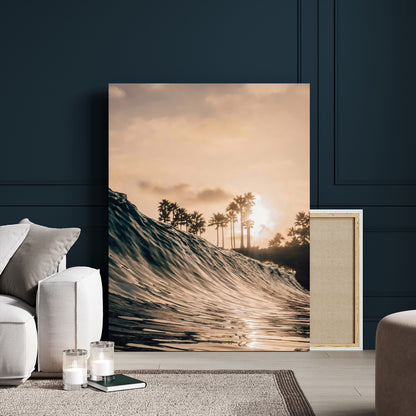 Golden sunset view of an ocean wave curling near palm trees, radiating warm tones perfect for coastal or tropical-themed decor.