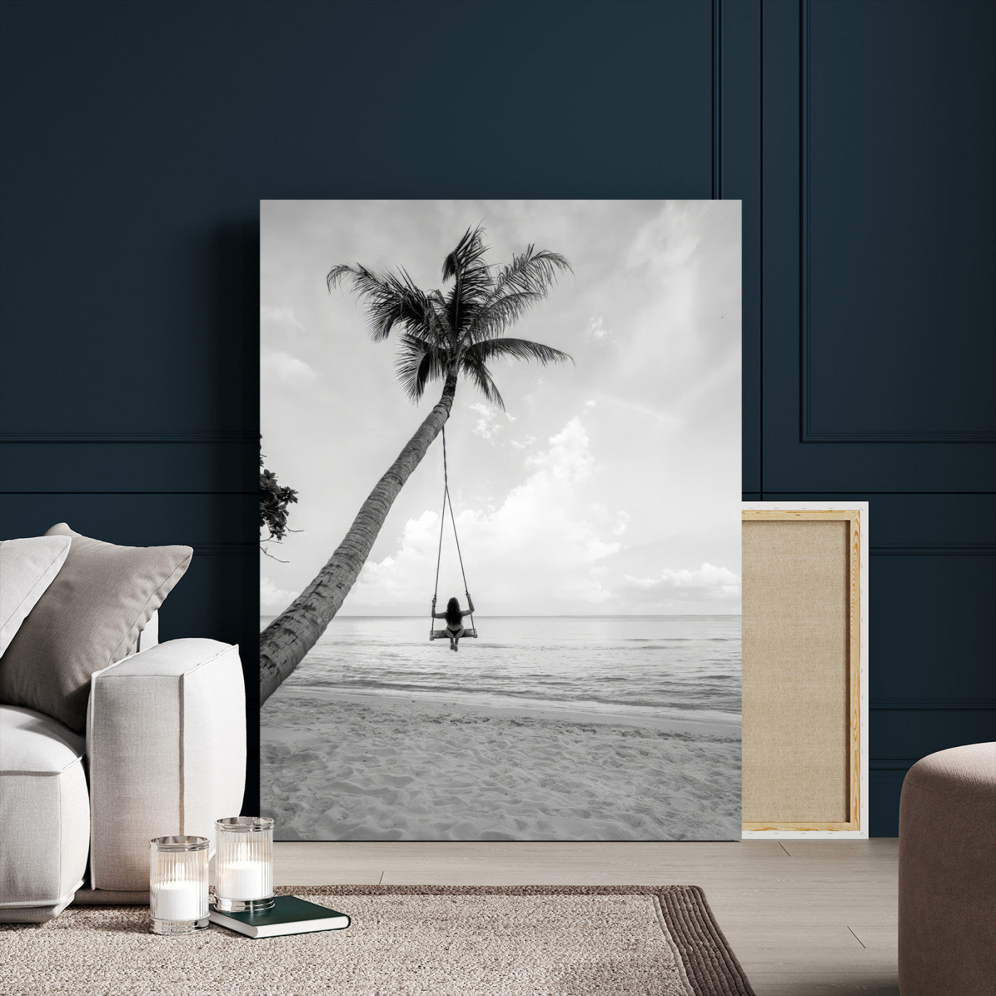 Monochrome photo of a woman swinging from a palm tree on a serene beach, ideal for minimalist or tropical coastal decor.