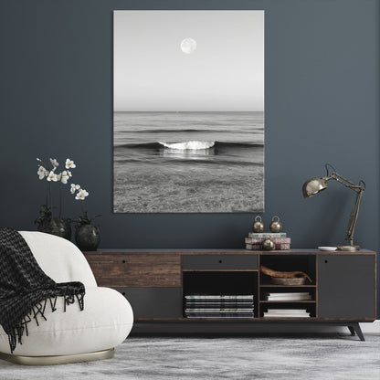 Black and white wall art of a calm ocean wave beneath a full moon, ideal for minimalist or monochrome coastal decor.