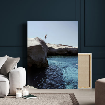 Canvas of a cliff diver above turquoise waters and rocky coastline under clear sky, ideal for adventurous minimalist or coastal home decor.
