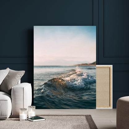 Close-up of ocean waves rolling gently toward the shore at sunset, creating a peaceful and minimalist coastal scene.