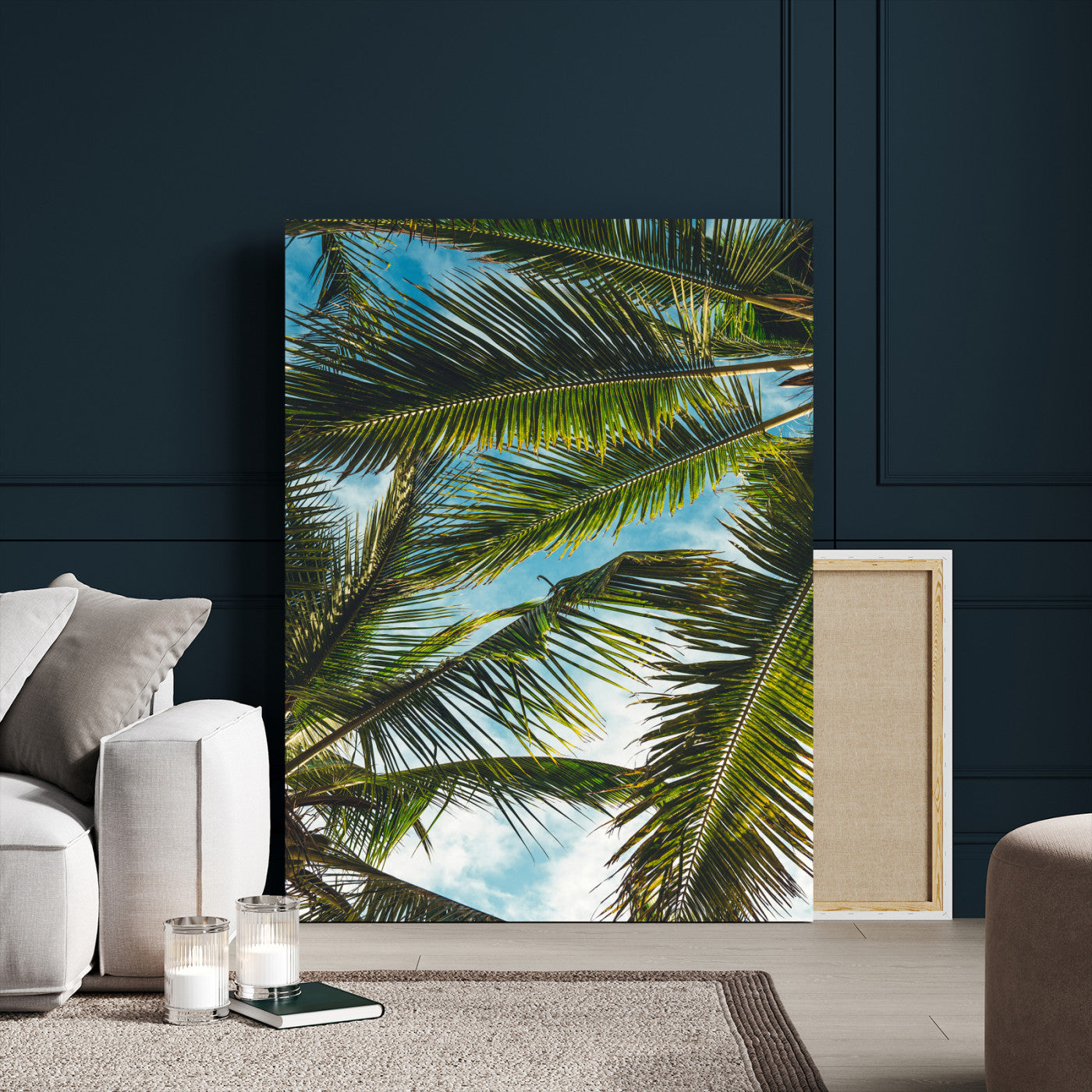 Looking up at lush green palm leaves against a bright blue sky, creating a tropical and relaxing coastal aesthetic.