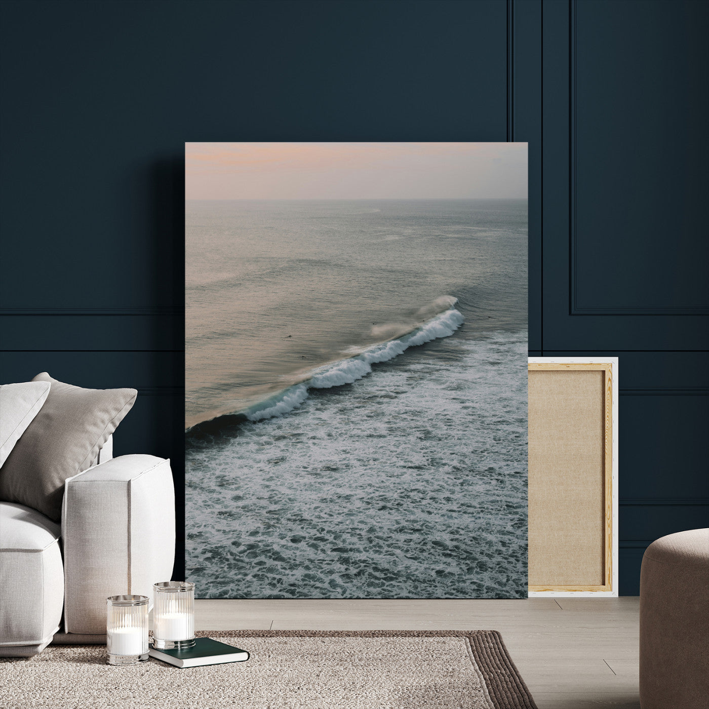 Aerial view of ocean waves rolling towards the shore under a soft sunset sky, creating a peaceful and minimalist coastal scene.