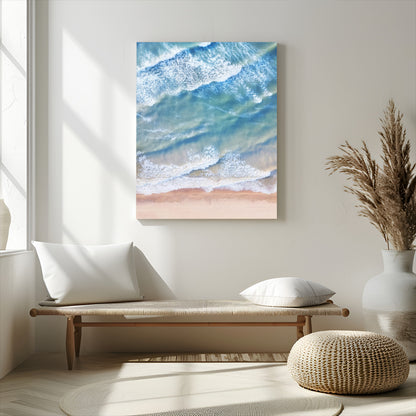 Aerial photo of soft blue waves meeting sandy shore, perfect for modern coastal or beach-themed decor with a light and tranquil aesthetic.