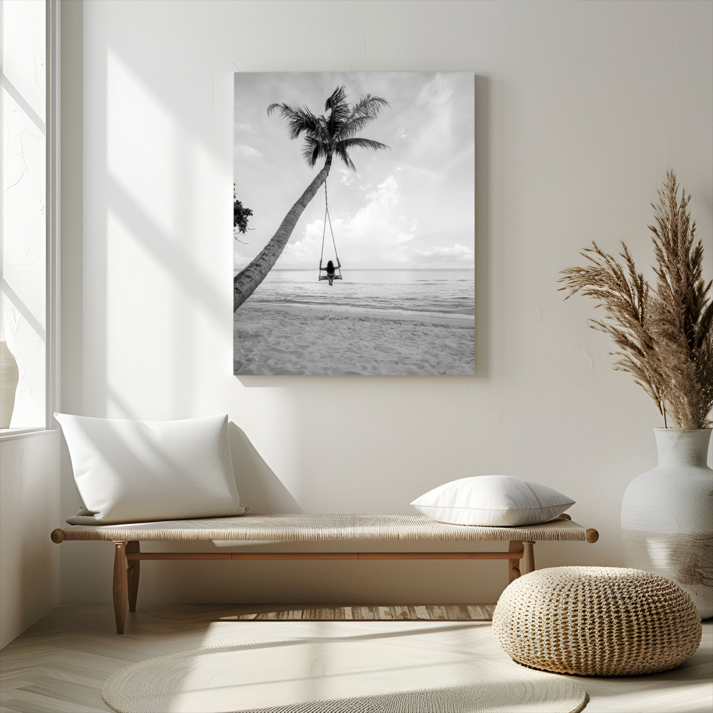 Monochrome photo of a woman swinging from a palm tree on a serene beach, ideal for minimalist or tropical coastal decor.