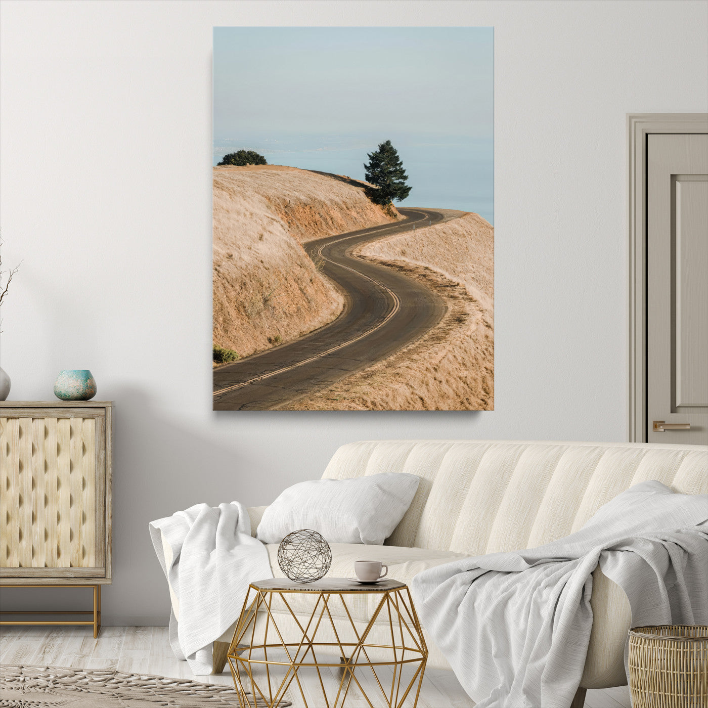 Earth-toned photograph of a winding road through golden hills, ideal for neutral or rustic-themed decor with a calming travel vibe.