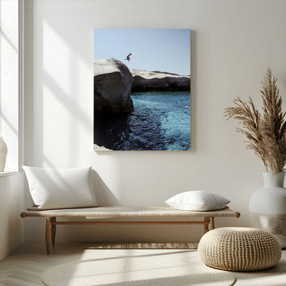 Canvas of a cliff diver above turquoise waters and rocky coastline under clear sky, ideal for adventurous minimalist or coastal home decor.