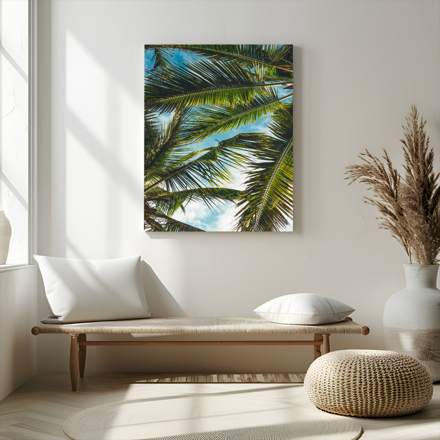 Looking up at lush green palm leaves against a bright blue sky, creating a tropical and relaxing coastal aesthetic.