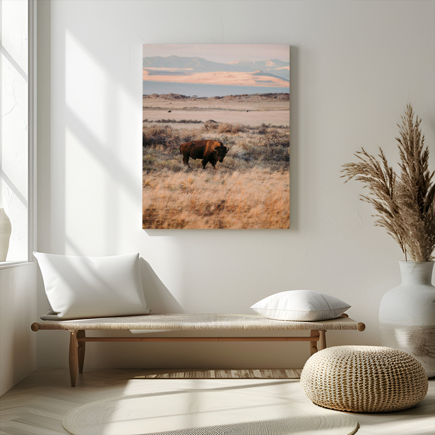 A solitary bison standing in golden prairie grass with distant mountains and soft sunset light, ideal for rustic, lodge, and western decor.
