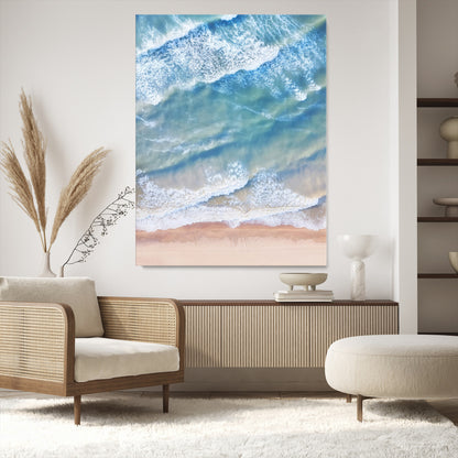 Aerial photo of soft blue waves meeting sandy shore, perfect for modern coastal or beach-themed decor with a light and tranquil aesthetic.