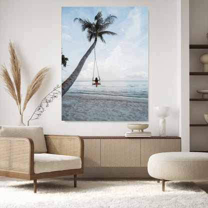 Wall art of a girl on a swing hanging from a palm tree over calm ocean waters, perfect for tropical or minimalist coastal decor.