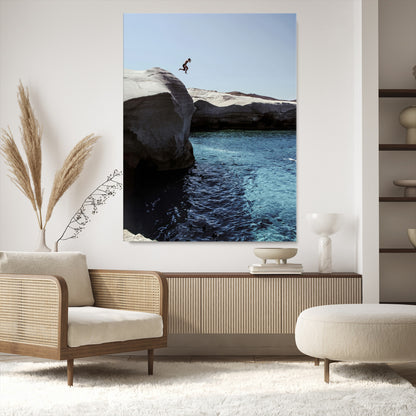 Canvas of a cliff diver above turquoise waters and rocky coastline under clear sky, ideal for adventurous minimalist or coastal home decor.