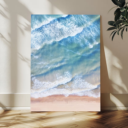 Aerial photo of soft blue waves meeting sandy shore, perfect for modern coastal or beach-themed decor with a light and tranquil aesthetic.