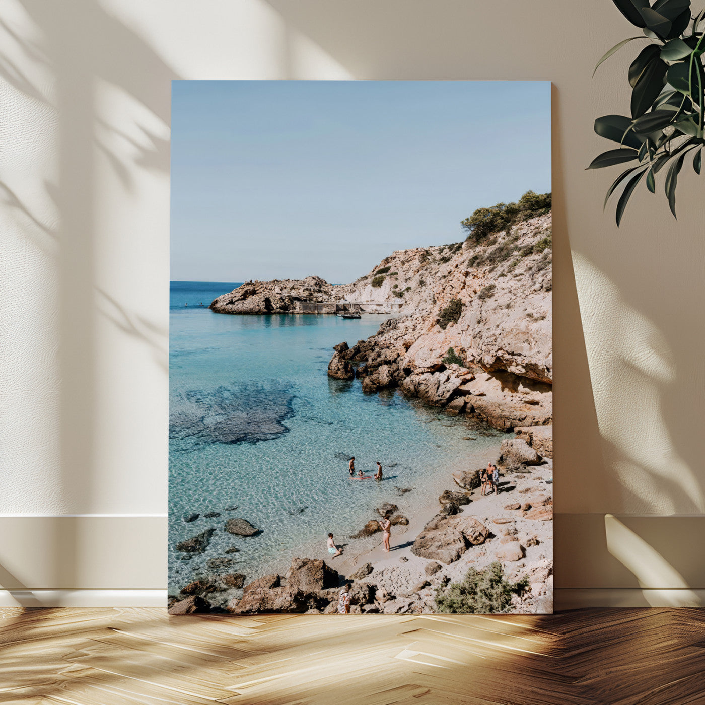 A vibrant coastal photo of a rocky Mediterranean cove with turquoise waters and beachgoers, ideal for boho coastal or summer-inspired interiors.