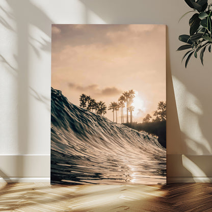 Golden sunset view of an ocean wave curling near palm trees, radiating warm tones perfect for coastal or tropical-themed decor.