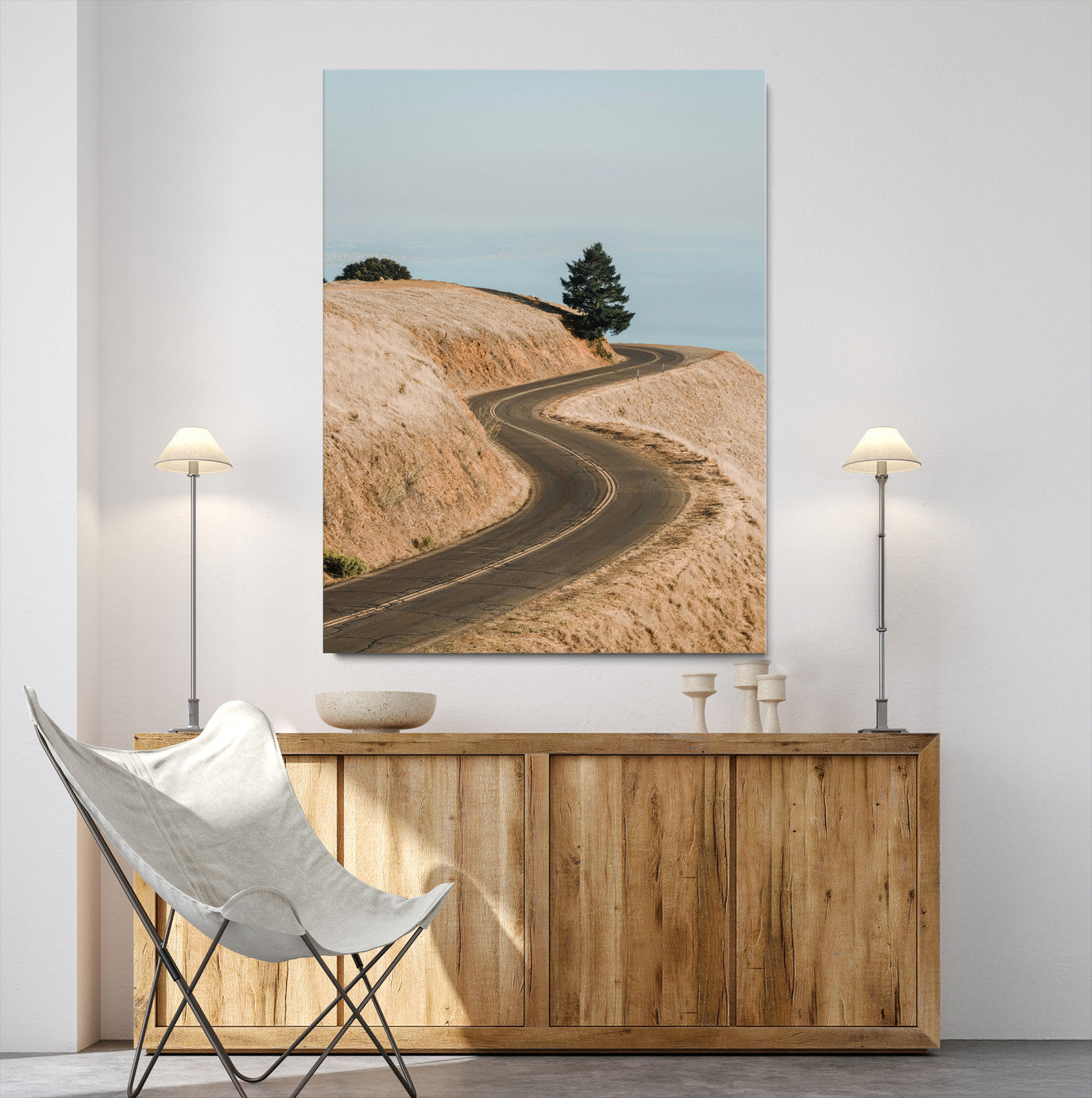 Earth-toned photograph of a winding road through golden hills, ideal for neutral or rustic-themed decor with a calming travel vibe.