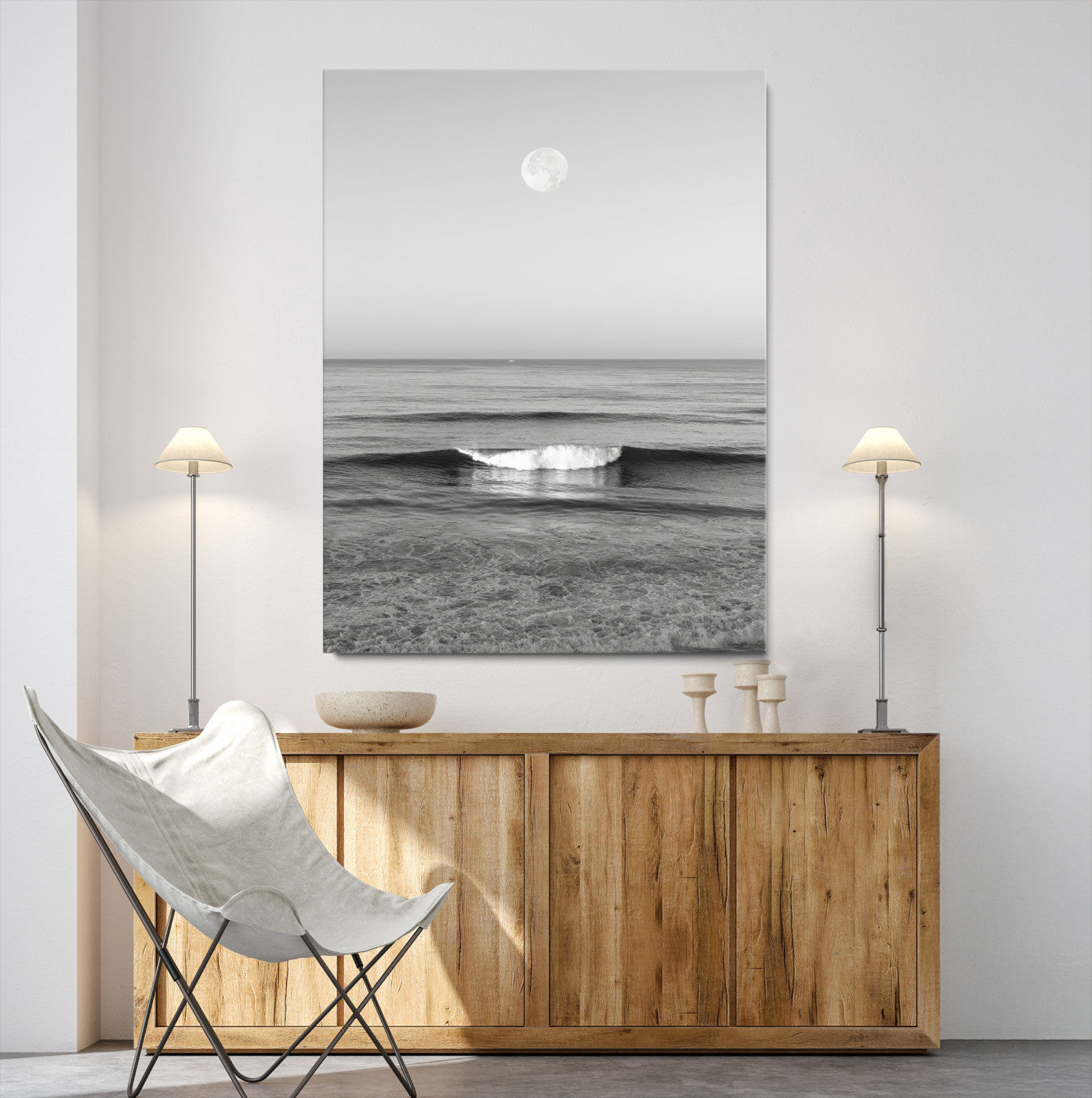 Black and white wall art of a calm ocean wave beneath a full moon, ideal for minimalist or monochrome coastal decor.