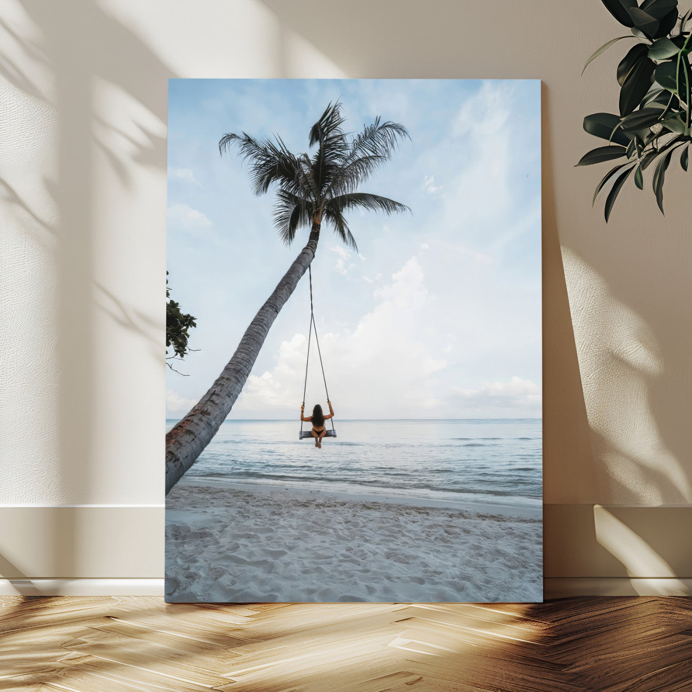 Wall art of a girl on a swing hanging from a palm tree over calm ocean waters, perfect for tropical or minimalist coastal decor.